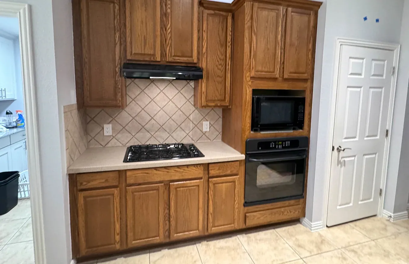 Refreshed kitchen with newly painted cabinets and updated hardware