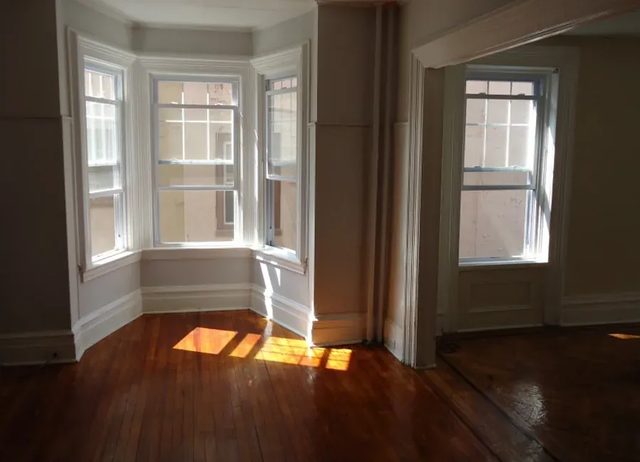 Bedroom with new warm-toned laminate flooring
