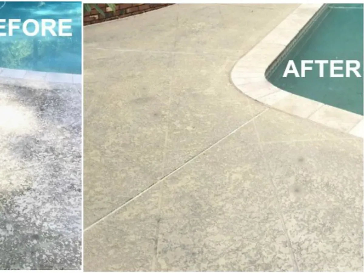 Driveway being pressure washed clean, half bright and half grimy